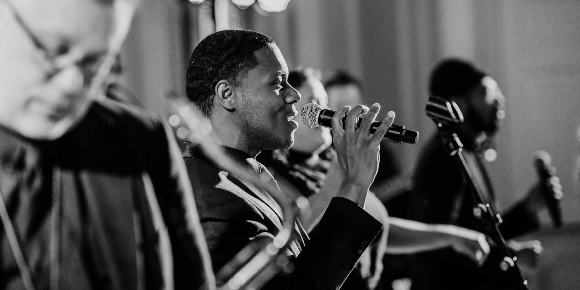 A large wedding reception with a packed dance floor and live band.